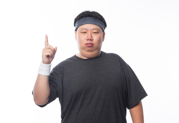 Naklejka premium Young Asian funny fat sport man poiting to copy space isolated on white background.