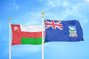Oman and Falkland Islands two flags on flagpoles and blue sky
