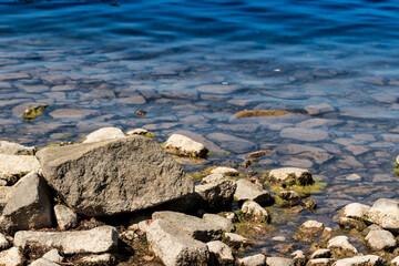 The rocky shore of the lake in the afternoon.