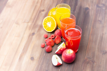 Citrus fruit and juice on table. multifruit juice. fresh vitamins, homemade refreshing fruit beverage. Orange, Strawberry, Apple.