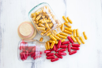 Herb capsule spilling out of a bottle . Nutritional Supplement, Vitamin Pill, Herbal Medicine for healthy eating supplement.