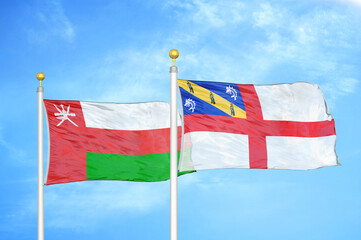 Oman and Herm two flags on flagpoles and blue sky