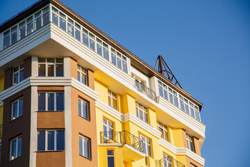Obraz premium Details of new constructed colorful multi-story building. Modern residential construction. Residential fund. Building of he city. New yellow house