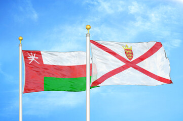 Naklejka na ściany i meble Oman and Jersey two flags on flagpoles and blue sky