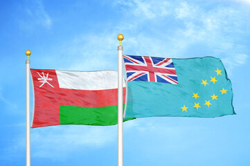 Oman and Tuvalu two flags on flagpoles and blue sky