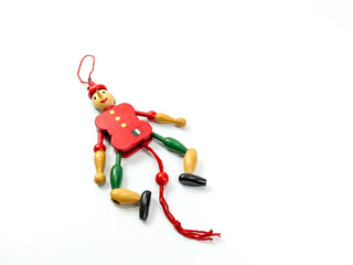 The wooden doll toy has a red-green color on a white background.