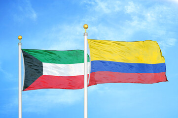 Kuwait and Colombia two flags on flagpoles and blue sky