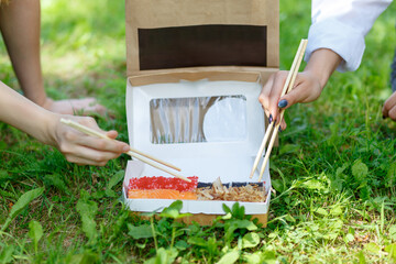 Two girls have a dinner with japanese sushi roll