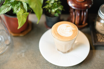 Cup of coffee with latte art pattern milk foam