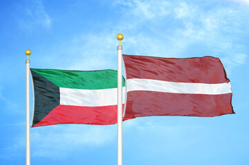 Kuwait and Latvia two flags on flagpoles and blue sky