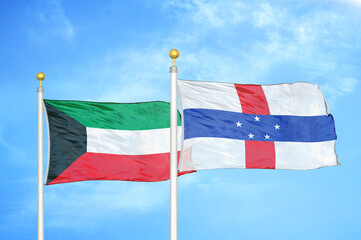 Kuwait and Netherlands Antilles two flags on flagpoles and blue sky