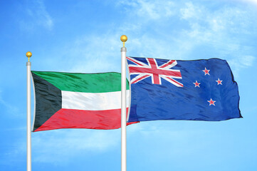 Kuwait and New Zealand two flags on flagpoles and blue sky