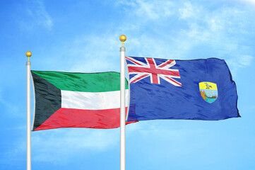 Kuwait and Saint Helena two flags on flagpoles and blue sky