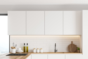 Fototapeta na wymiar Cabinets in white kitchen interior