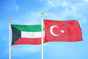 Kuwait and Turkey two flags on flagpoles and blue sky
