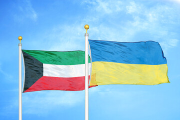 Kuwait and Ukraine two flags on flagpoles and blue sky