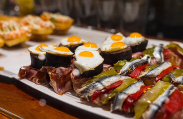 Delicious close up of pintxos/pinchos from San Sebastian (Donostia, Basque Autonomous community, Spain). Typical meal, kind of like spanish tapas. Contains eggs, fish, bread and more 