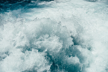 Frozen splashing in rapids of powerful mountain river. Surf of clear water  close-up. Nature...
