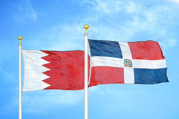 Bahrain and Dominican Republic two flags on flagpoles and blue sky
