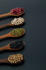 Collection of whole grains seeds isolated on black background. Healthy diet raw ingredients.