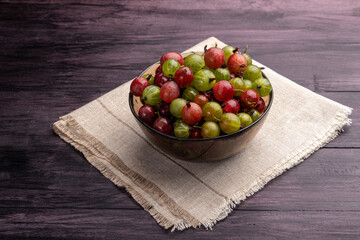 bowl of gooseberries on a dark background
