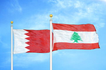 Bahrain and Lebanon two flags on flagpoles and blue sky