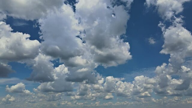 Good weather white fluffy clouds in the blue sky clearing day view of timelapse