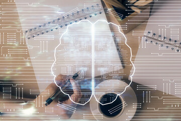 Multi exposure of woman's writing hand on background with brain hologram. Concept of brainstorming.