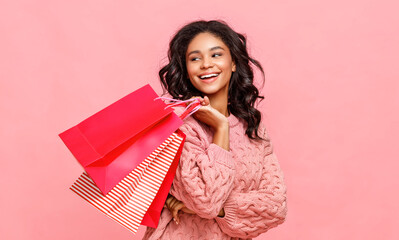 Friendly ethnic shopper with paper bags.