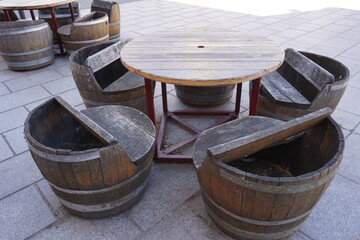 Fototapeta premium old wooden wine barrels transformed in table and chairs