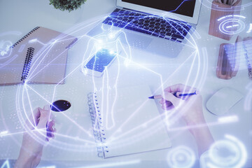 Education theme hologram over woman's hands writing background. Concept of study. Double exposure