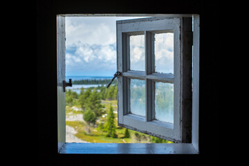 Vintage Open Window with magnificent view from wooden lighthouse on Stor-rabben island over archipelago landscape with islands and forests in northern Europe, Sweden.