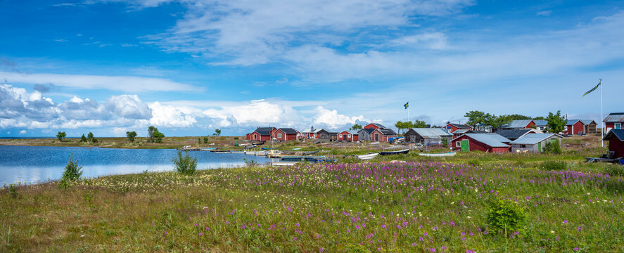 Traditional Fishing Village and Boat houses by the lake in Sweden on Stor-Rabben Island, Near Pitea in the Archipelago of Gulf of Bothnia in Northern Scandinavia.