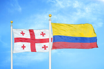 Georgia and Colombia two flags on flagpoles and blue sky