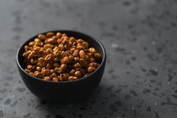 dried seaberry buckthorn in olive bowl on terrazzo countertop with copy space