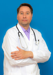 vertical image Photo of brunet hair bristle doc assistant folded hands over chest stand isolated blue background