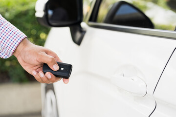 Close up car keys and remote control car alarm systems hold in hand