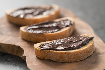Rustic ciabatta with organic chocolate cream on olive wood board