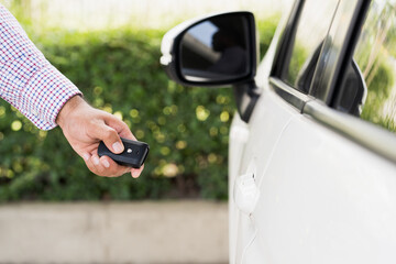 Close up car keys and remote control car alarm systems hold in hand