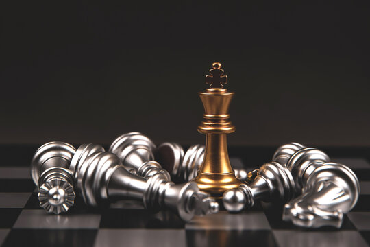 King golden chess standing of the falling silver chess with dark background concepts of leadership and business strategy management and leadership.