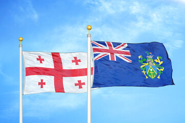 Georgia and Pitcairn Islands two flags on flagpoles and blue sky