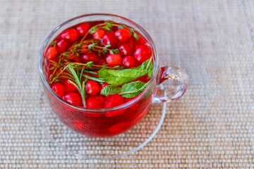 Herbal tea with mint, thyme, rosemary and cranberries. Vitamin drink for health.
