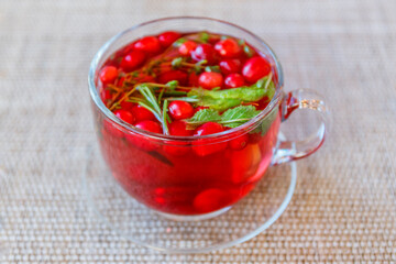 Herbal tea with mint, thyme, rosemary and cranberries. Vitamin drink for health.