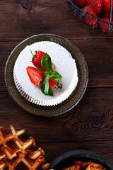 Soft ricotta cheese with strawberries on a dark background. The concept of a healthy Breakfast. Natural biological products. Copy of the space.Vertical photo. The concept of still life.