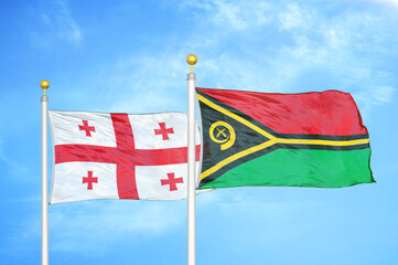 Georgia and Vanuatu two flags on flagpoles and blue sky
