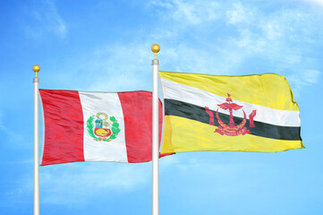 Peru and Brunei two flags on flagpoles and blue sky