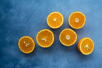Sliced orange on blue background. Fresh oranges.