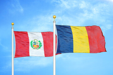 Peru and Chad two flags on flagpoles and blue sky