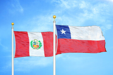 Peru and Chile two flags on flagpoles and blue sky