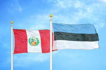 Peru and Estonia two flags on flagpoles and blue sky